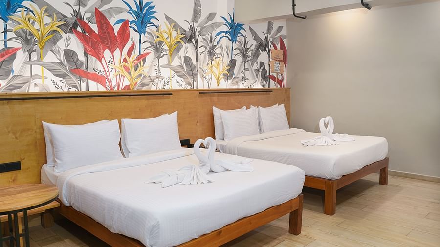 A large bed placed next to another bed in Urban Corner Room at Indie Stays Resort, Goa